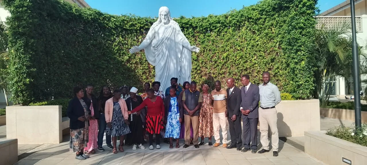A Temple Bound group gathered together beside the Christus statue on temple grounds